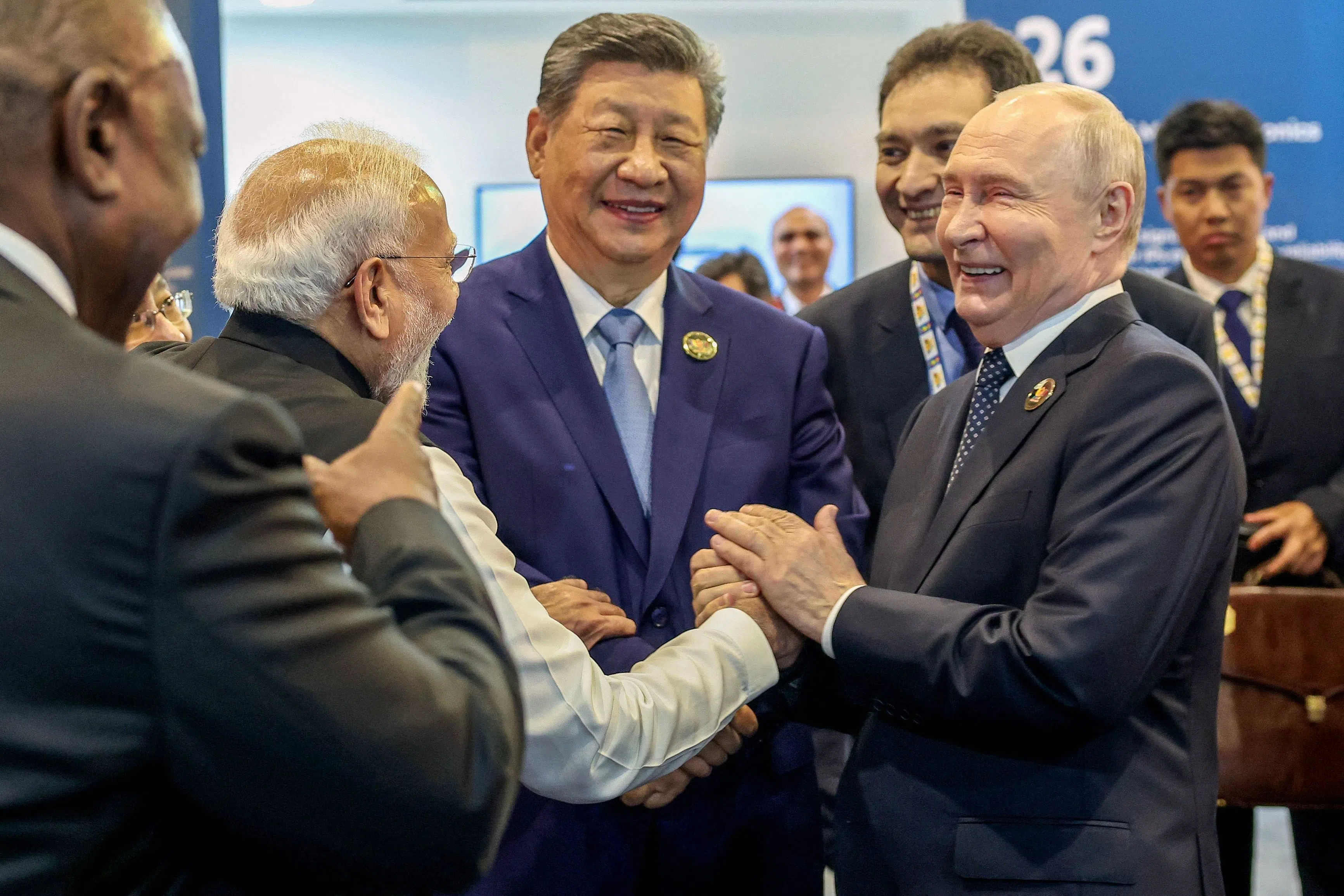 This handout photograph taken on 12 September 2026 and released by India's Ministry of External Affairs shows India's Prime Minister Narendra Modi (second from left), China's President Xi Jinping (centre) and Russia's President Vladimir Putin (right) sharing a light moment during the 18th BRICS Summit in New Delhi.