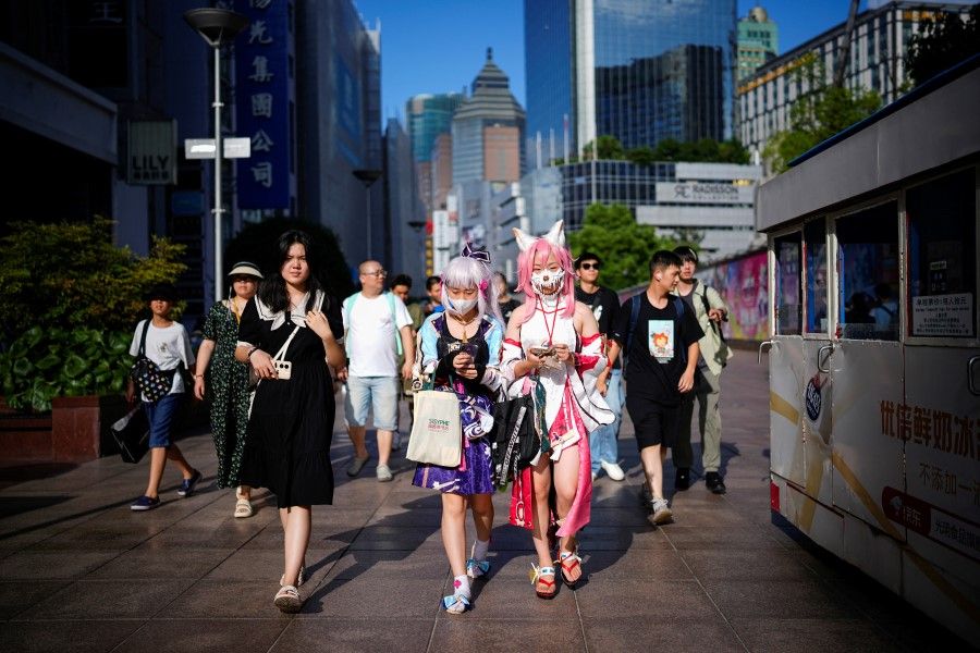 Cosplayers walk on a shopping street, in Shanghai, China, 31 July 2023. (Aly Song/Reuters)