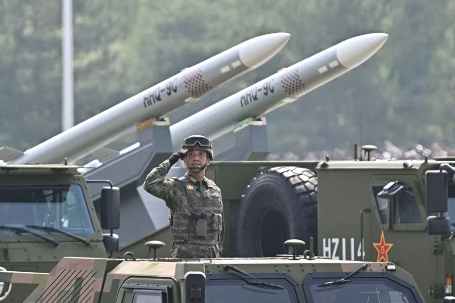 A Chinese military officer salutes in front of a truck carrying HHQ-9C surface-to-air missiles during a military parade marking the 80th anniversary of victory over Japan and the end of World War II, in Beijing’s Tiananmen Square, 3 September 2025. (Pedro Pardo/AFP)