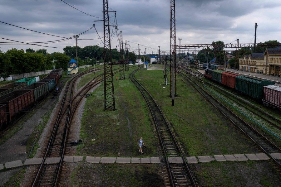 A young woman walks in the train station of Pokrovsk, eastern Ukraine, on 2 August 2022. (Bulent Kilic/AFP)