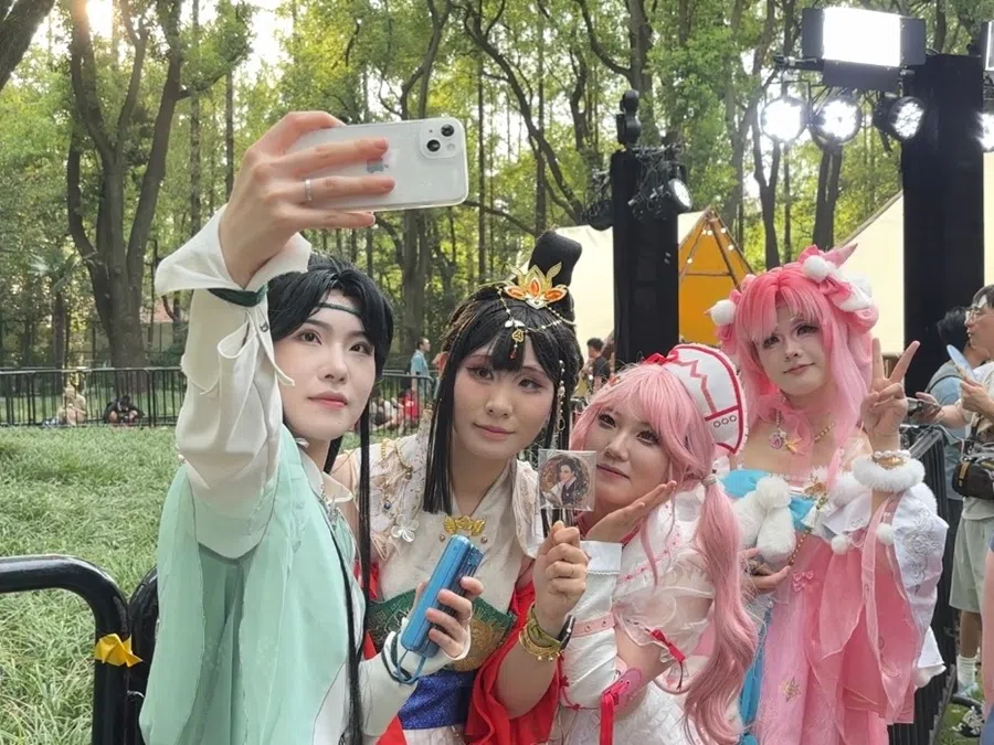 Cosplayers take photographs at Red Land.