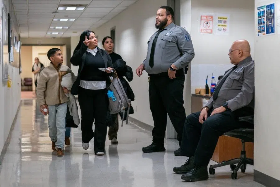 A family of respondents interacts with security guards at US immigration court in Manhattan, in New York City, US, on 5 January 2026. (David ‘Dee’ Delgado/Reuters)
