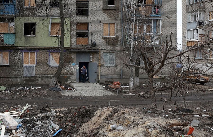 A local resident stands in the doorway of a building partially destroyed by Russian shelling in Kupiansk, Kharkiv region, Ukraine, on 7 March 2023. (Anatolii Stepanov/AFP)