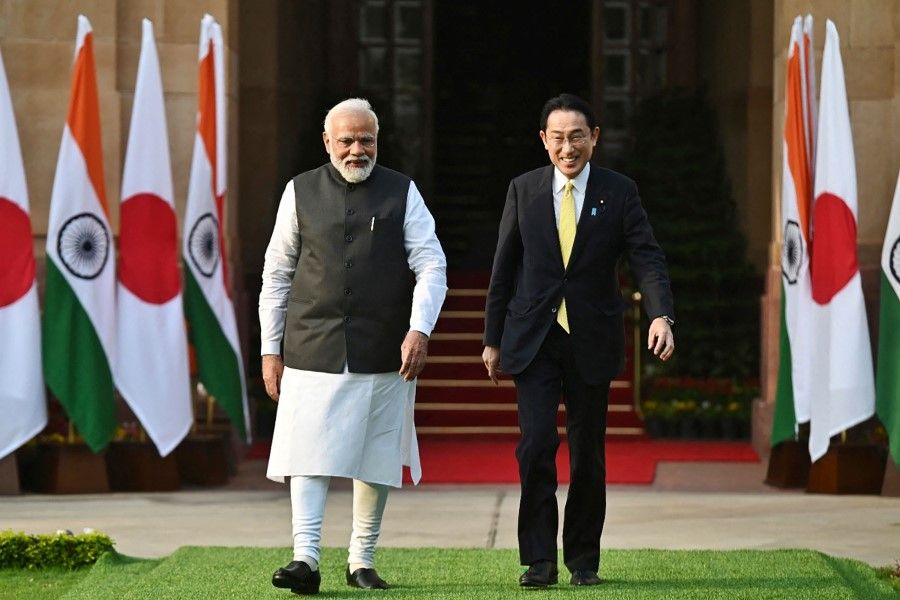 This handout photograph taken on 19 March 2022 and released by the Indian Press Information Bureau (PIB) shows Japan's Prime Minister Fumio Kishida (right) and his Indian counterpart Narendra Modi arriving for a photo opportunity before their meeting, at the lawns of the Hyderabad House in New Delhi. Kishida urged Modi to take a tougher line on Russia's invasion of Ukraine, but a joint statement after talks in Delhi fell short of condemning Moscow's actions. (Indian Press Information Bureau/AFP)