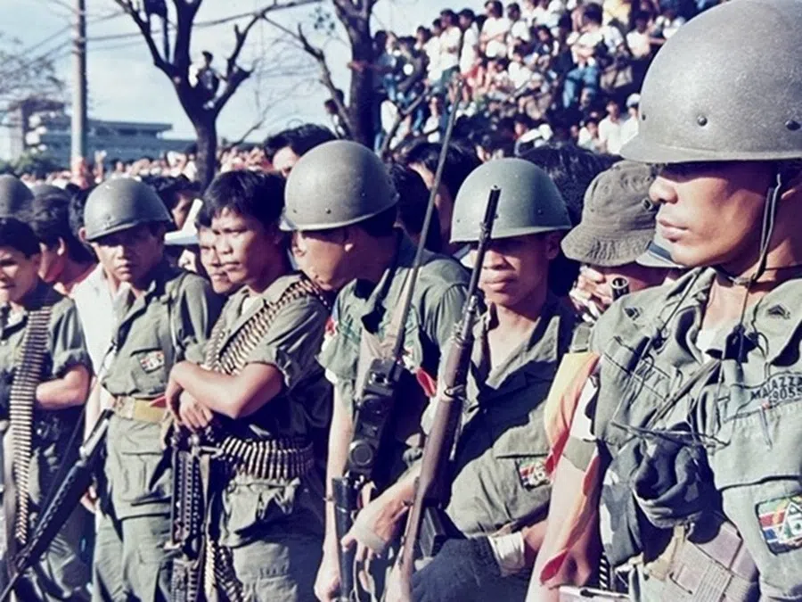 Government troops deployed to suppress a military rebellion in the Philippines in 1987.