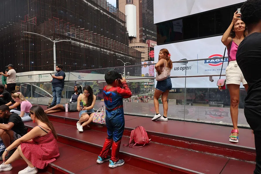 People sit on the red steps in Times Square on 28 August 2024 in New York City, US.