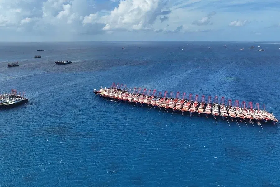 This handout photo taken on 2 December 2023 and released on 3 December by the Philippine Coast Guard (PCG) shows an aerial view of Chinese vessels gathered by Whitsun Reef, around 320 kilometres west of Palawan Island, in disputed waters of the South China Sea. (Handout/Philippine Coast Guard (PCG)/AFP)