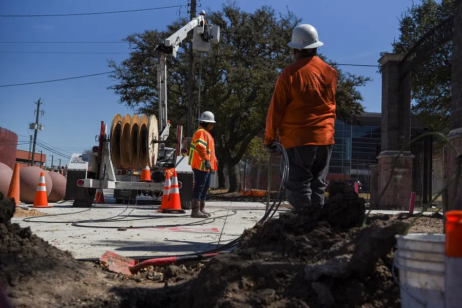 A crew works to restore 5G following an unprecedented winter storm in Houston, Texas, US, 3 March 2021. (Callaghan O'Hare/Reuters)