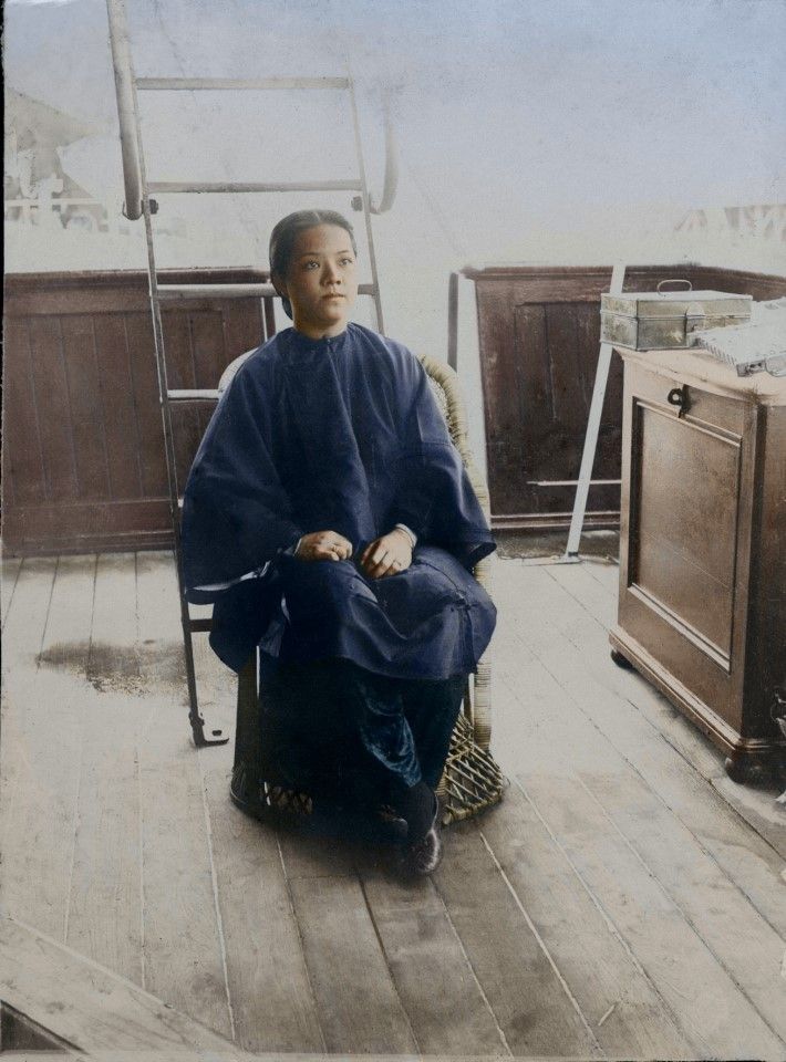 The wife of a coolie agent in the cabin. The photograph shows that the agent was not only a labour leader in his hometown in China, but may also have engaged in international trading, with trading posts in Fujian and Singapore, which is why he was able to bring his wife with him to Singapore. Furthermore, their status was different from the average coolie, having their own private space and being accorded the same treatment as a boss.