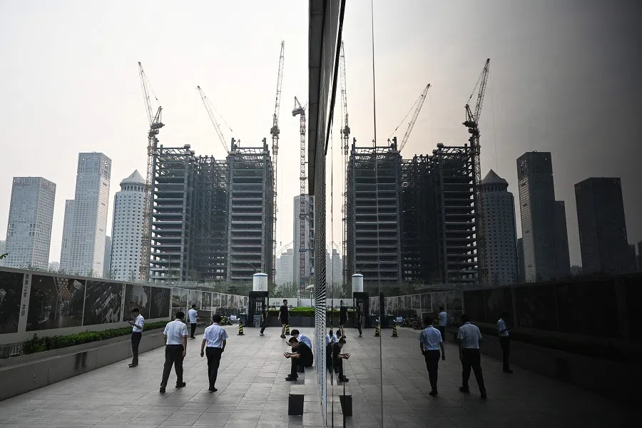 Office workers walk in the central business district of Beijing, China, on 11 July 2024. (Greg Baker/AFP)