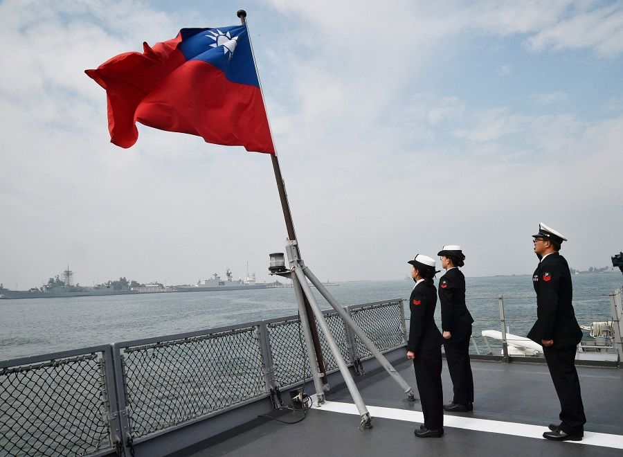 In this file photo taken on 31 January 2018, Taiwanese sailors salute the island's flag on the deck of the Panshih supply ship after taking part in annual drills, at the Tsoying naval base in Kaohsiung, Taiwan. (Mandy Cheng/AFP)