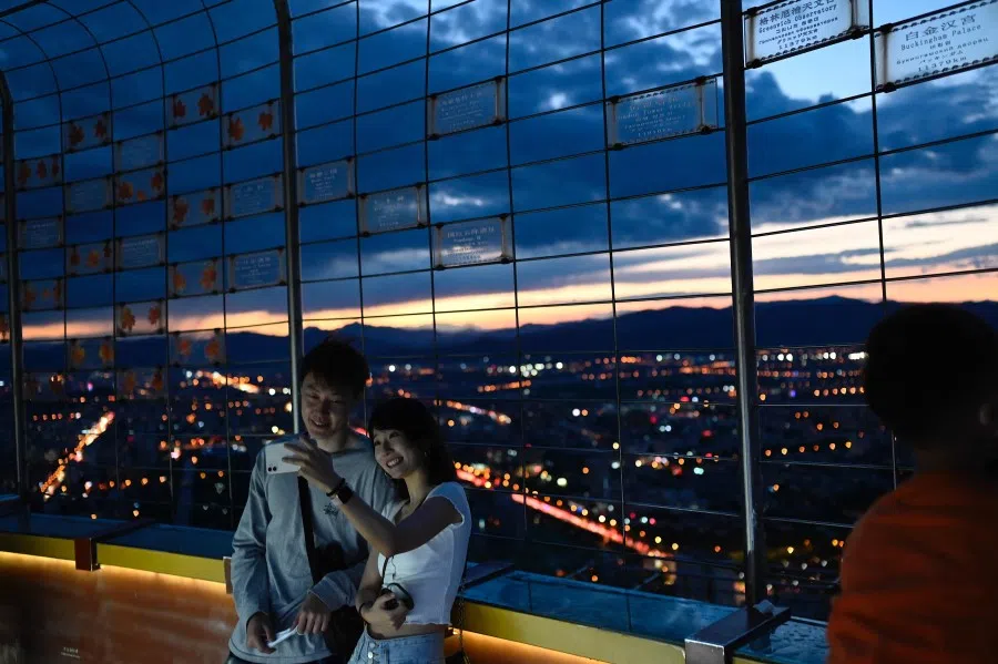 A couple takes a selfie at the Central Television Tower in Beijing on 26 August 2021. (Jade Gao/AFP)