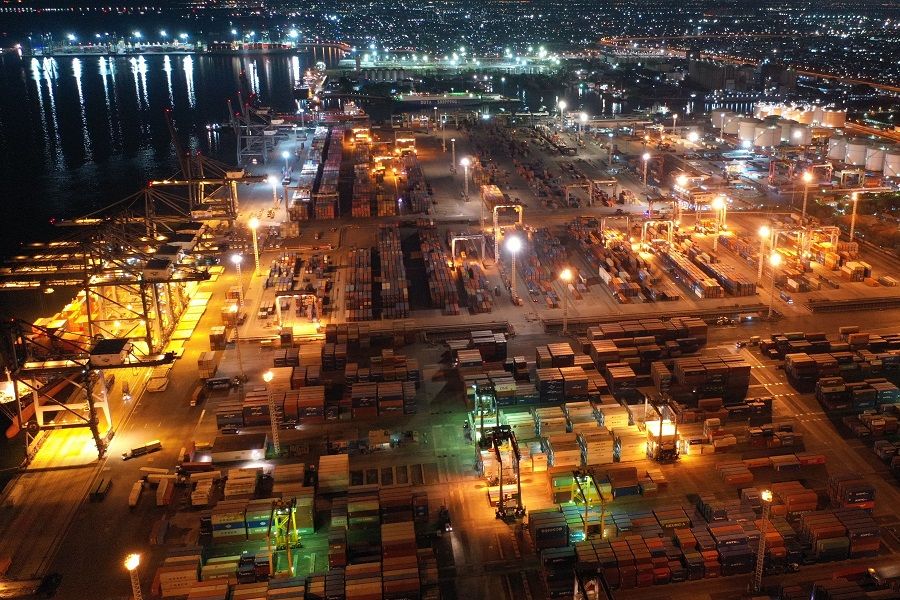 Shipping containers are stacked near gantry cranes at the Port of Tanjung Priok in Jakarta, Indonesia, on 14 November 2020. (Dimas Ardian/Bloomberg)
