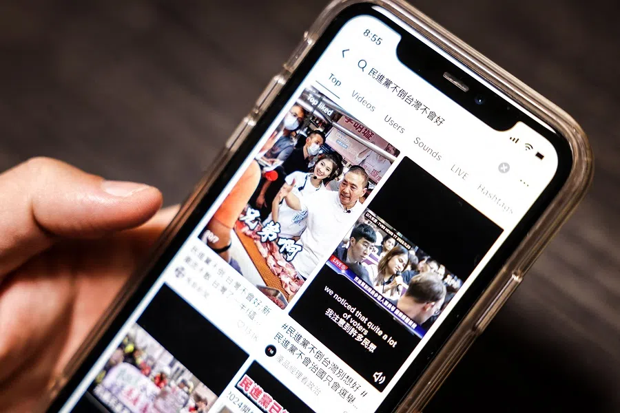 This photo illustration taken on 22 December 2023 shows a user on the TikTok app looking at videos with the hashtag "Taiwan will only be better if the DPP falls", referring to Taiwan's Democratic Progressive Party (DPP), in Taipei, Taiwan. (I-Hwa Cheng/AFP)