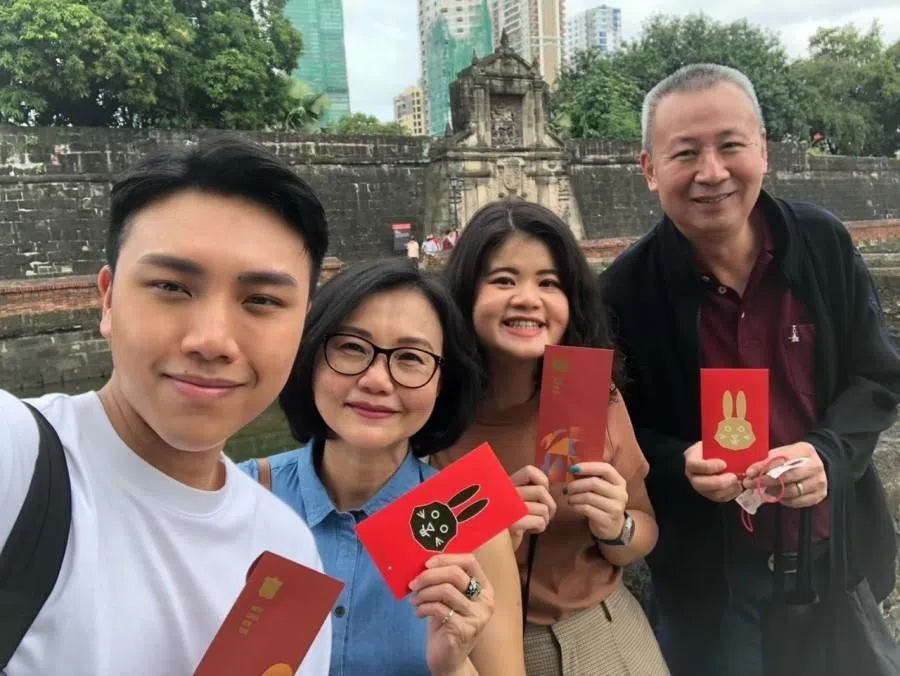 In 2023, we celebrated the New Year in Manila. Our family posed for a photo holding red packets in front of Fort Santiago.