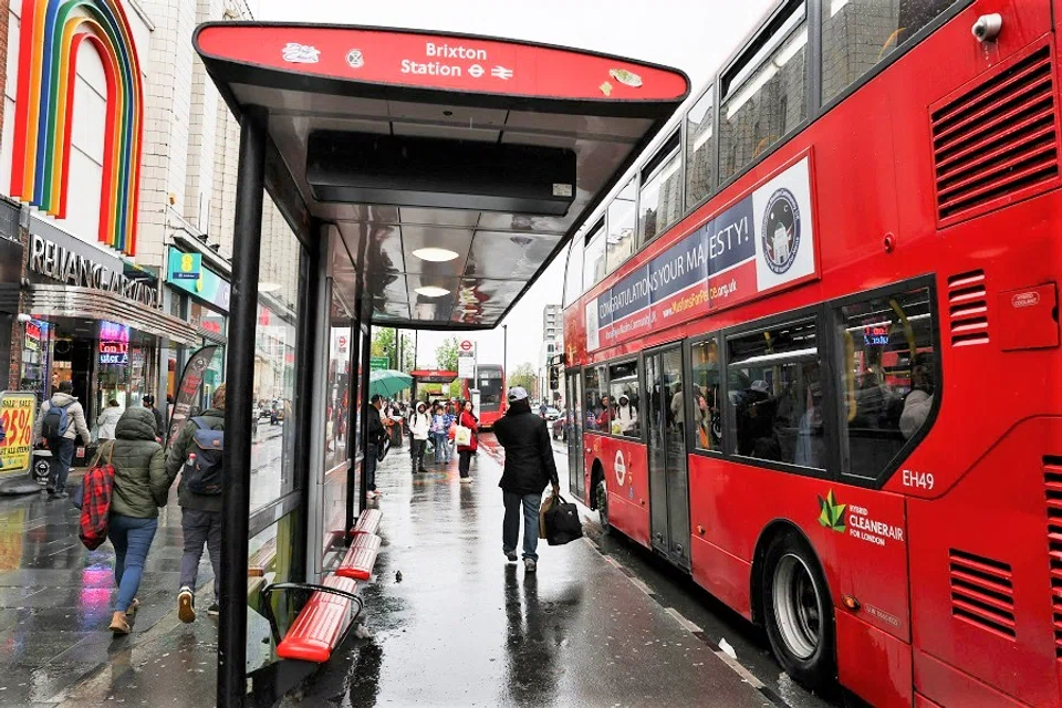 People walk outside Brixton Underground Station, in London, Britain, 6 May 2023. (Emilie Madi/Reuters)