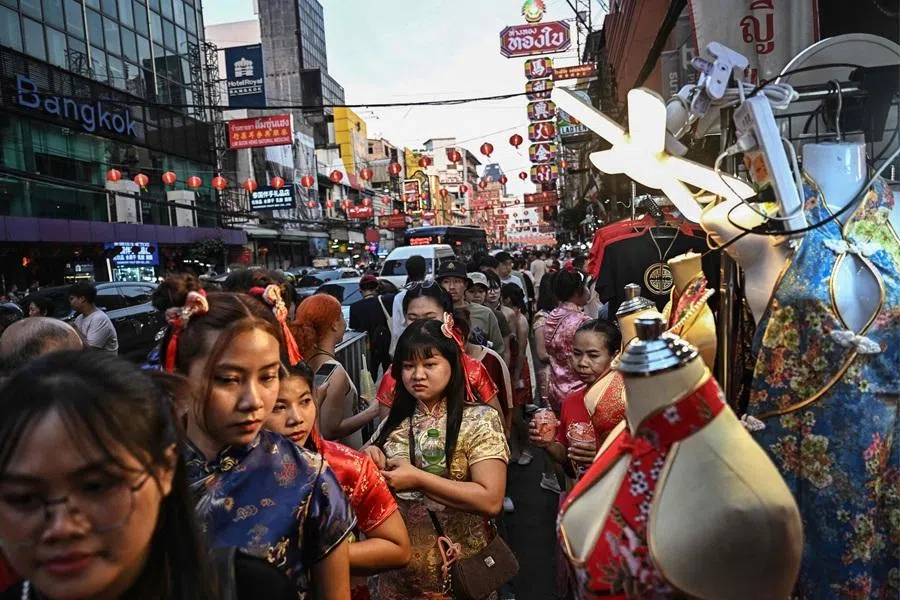 People walk down Yaowarat Road in Chinatown in Bangkok, Thailand, on 16 February 2026. (Lillian Suwanrumpha/AFP)
