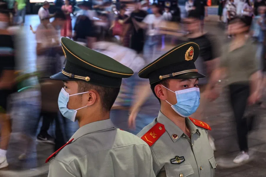 Chinese paramilitary policemen stand guard on a street in Shanghai, China, on 5 October 2021. (Hector Retamal/AFP)