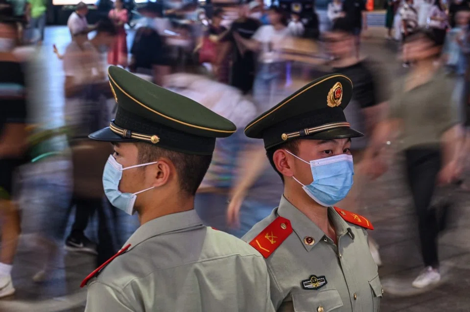 Chinese paramilitary policemen stand guard on a street in Shanghai, China, on 5 October 2021. (Hector Retamal/AFP)