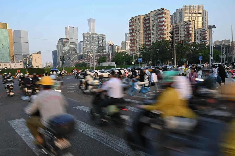 People commute in Beijing, China on 12 May 2026. (Pedro Pardo/AFP)