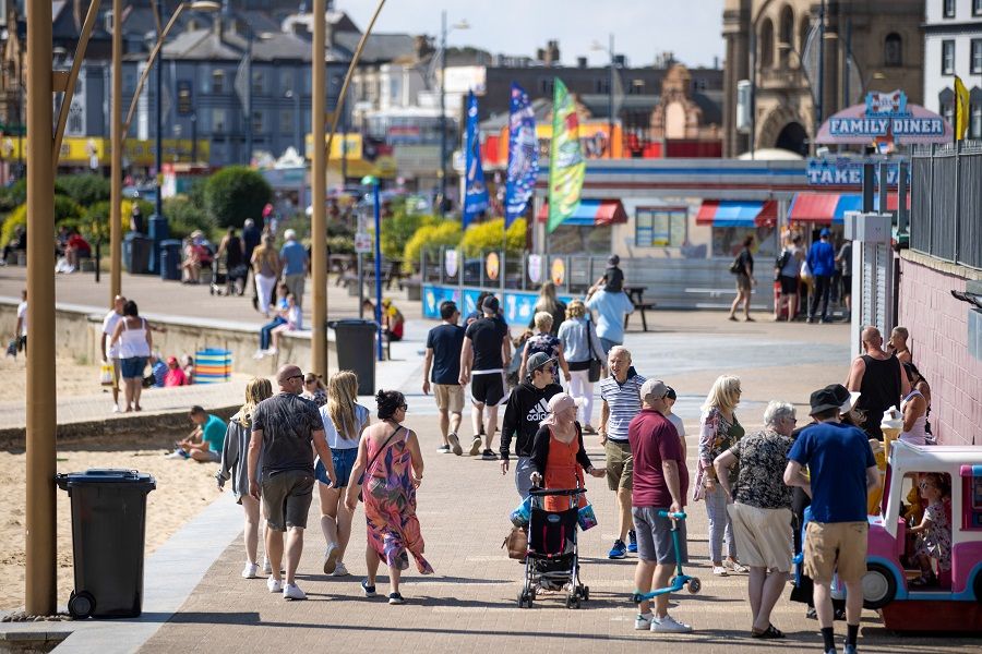 Holidaymakers walk along the seafront in Great Yarmouth, UK, on 4 August 2021. (Jason Alden/Bloomberg)