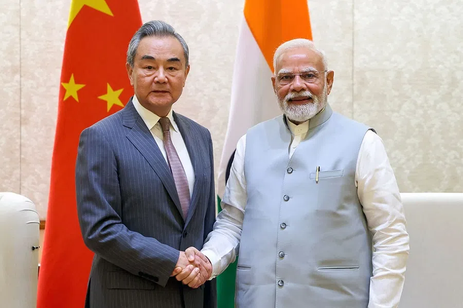 This handout photograph taken on 19 August 2025 and released by the Indian Press Information Bureau (PIB) shows India’s Prime Minister Narendra Modi shaking hands with Beijing’s Foreign Minister Wang Yi during a bilateral meeting in New Delhi on 19 August 2025. (Indian Press Information Bureau (PIB)/AFP)