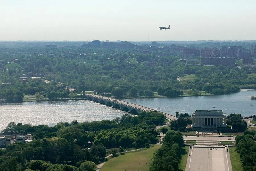 A plane flies over the Lincoln Memorial, Arlington Memorial Bridge and Arlington Cemetery as it prepares for landing at Ronald Reagan Washington National Airport in Washington, DC, US, on 16 April 2026. (Kylie Cooper/Reuters)