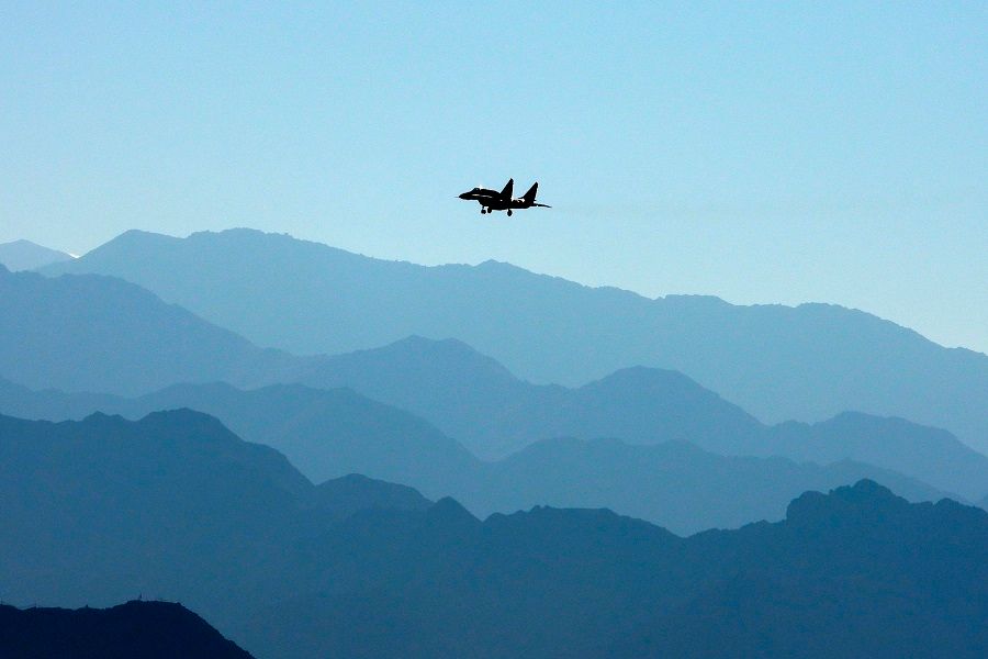 An Indian Air Force fighter jet flies over a mountain range in Leh, the joint capital of the union territory of Ladakh bordering China, on 15 September 2020. (Mohd Arhaan Archer/AFP)
