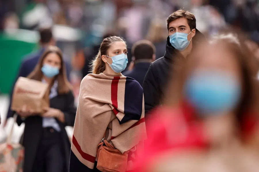 People walk in the Montorgueil street in Paris, France, 25 February 2021. (Sarah Meyssonnier/Reuters)