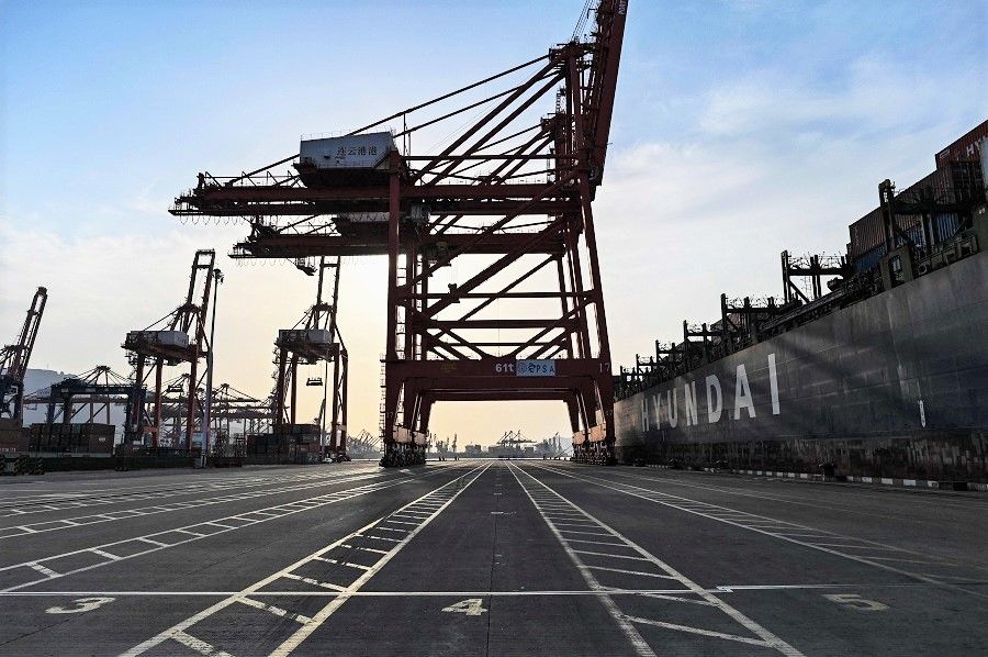 A general view shows a cargo ship and cranes at the port of Lianyungang, Jiangsu province, China, on 24 March 2021. (Hector Retamal/AFP)