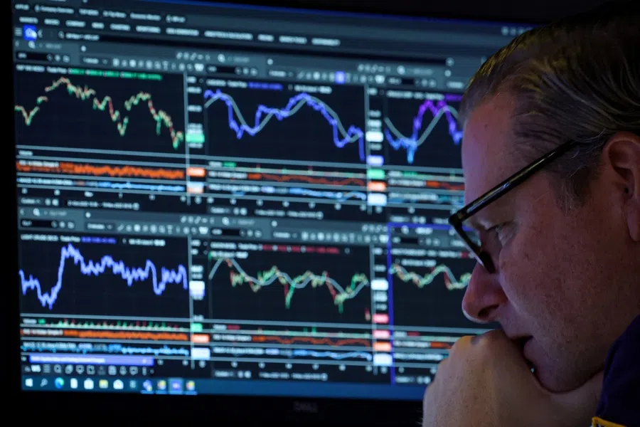 A specialist trader works inside a booth on the floor at the New York Stock Exchange (NYSE) in New York City, US, 19 November 2025.