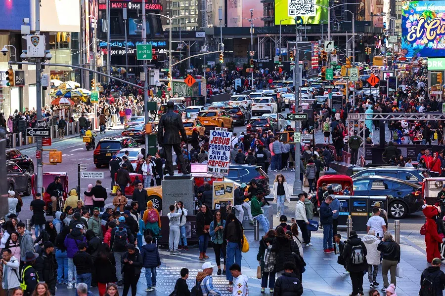 Visitors and tourists making their way through Times Square in New York City on 7 April 2024. (Charly Triballeau/AFP)