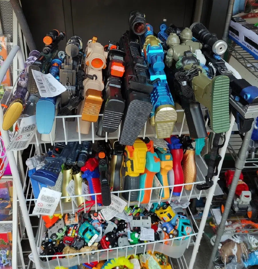 Newspaper stand selling toy guns.