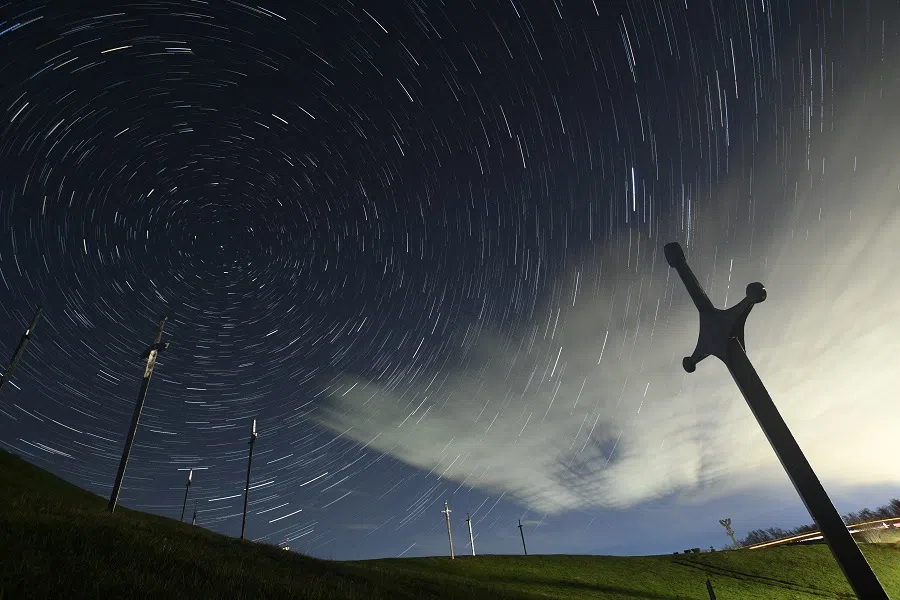 A view shows stars and meteor trails in the night sky above the Battle of Didgori memorial complex during the Lyrid meteor shower in Didgori, Georgia, 22 April 2023, in this composite image of 14 separate photographs. (Irakli Gedenidze/Reuters)