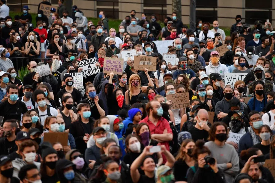 Protestors hold up placards and raise their arms during a "Black Lives Matter" demonstration over the death of George Floyd by a Minneapolis police officer, at Brooklyn Borough Hall, New York, 1 June 2020. (Angela Weiss/AFP)