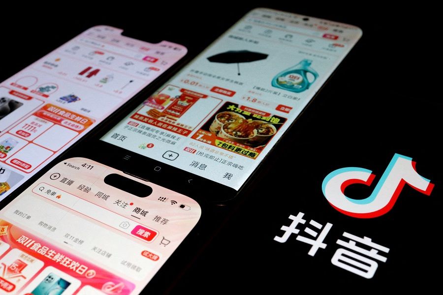 The logo of Douyin is displayed next to mobile phones displaying the e-commerce sites on the app, in this illustration picture taken 25 October 2023. (Florence Lo/Illustration/Reuters)