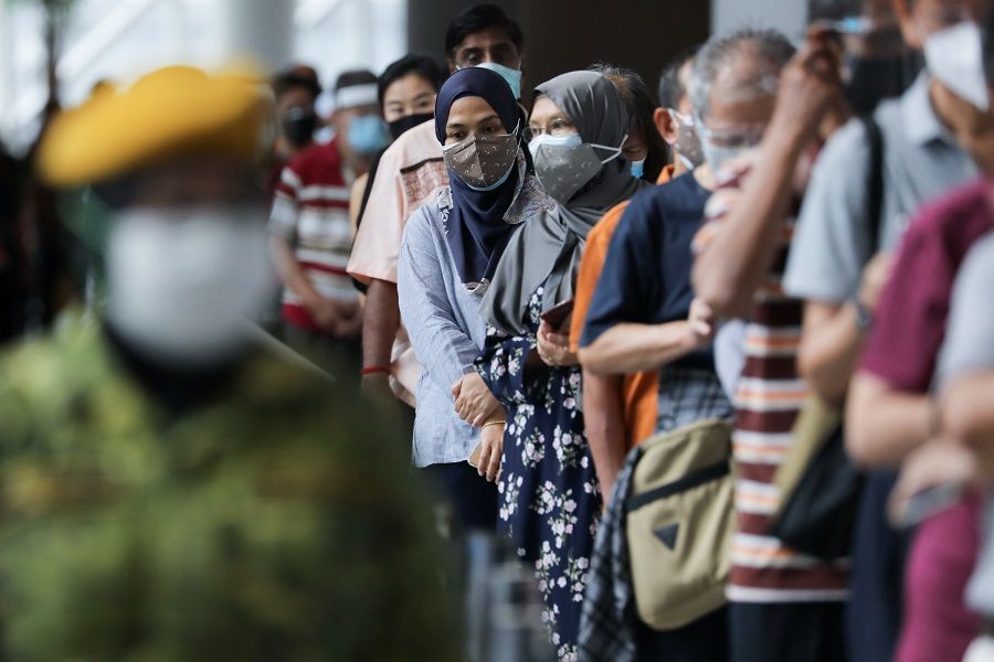 People wait to receive Covid-19 vaccines at a vaccination centre in Kuala Lumpur, Malaysia, 31 May 2021. (Lim Huey Teng/Reuters)