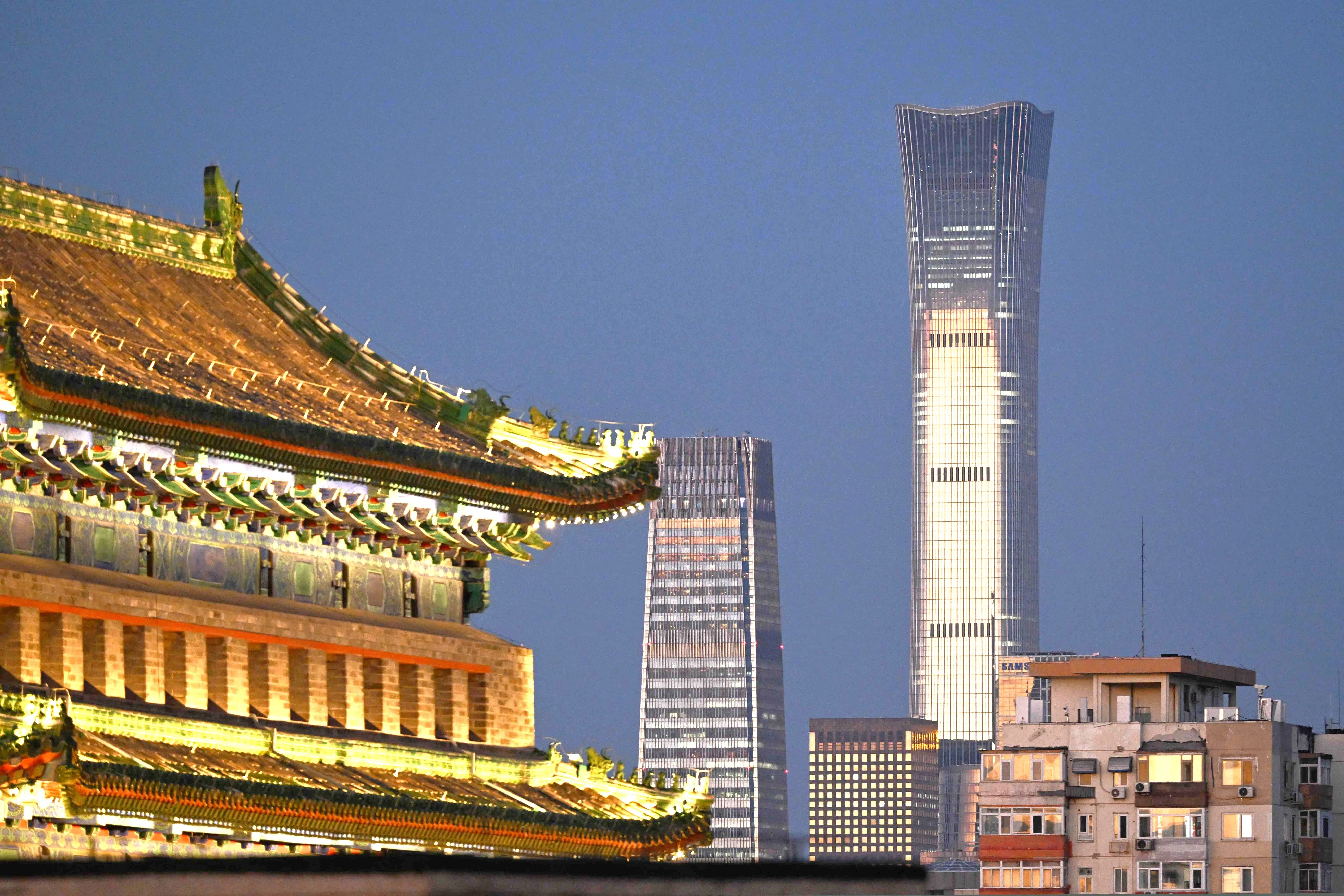 The CITIC Tower, known as China Zun, Beijing’s tallest building, is seen behind residential buildings (right) and Jianlou (left) one of the two traditional towers at Qianmen at the south end of Tiananmen Square, in Beijing on 9 September 2026.