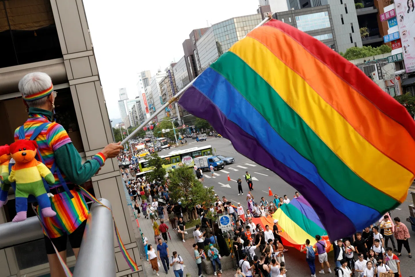 A participant holds a rainbow flag on a balcony during the LGBT Pride parade in Taipei, Taiwan October 26, 2019. (REUTERS/Eason Lam)