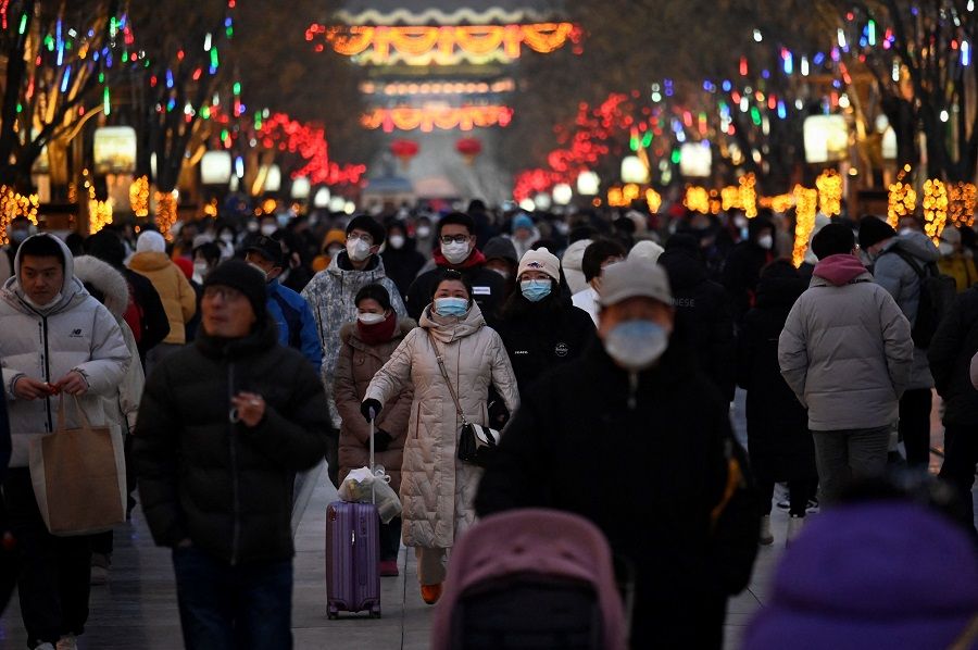 People visit a business street during the Spring Festival in Beijing, China, on 25 January 2023. (Wang Zhao/AFP)