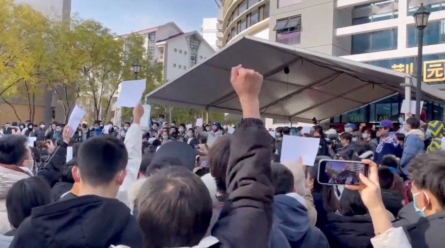 Students take part in a protest against COVID-19 curbs at Tsinghua University in Beijing, China seen in this still image taken from a video released 27 November 2022 and obtained by Reuters. (Reuters)
