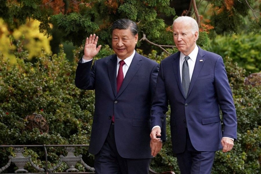 Chinese President Xi Jinping waves as he walks with U.S. President Joe Biden at Filoli estate on the sidelines of the Asia-Pacific Economic Cooperation (APEC) summit, in Woodside, California, US, on 15 November 2023. (Kevin Lamarque/Reuters)