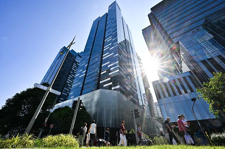 People walk at Marina View in Singapore on 5 June 2024. (SPH Media)