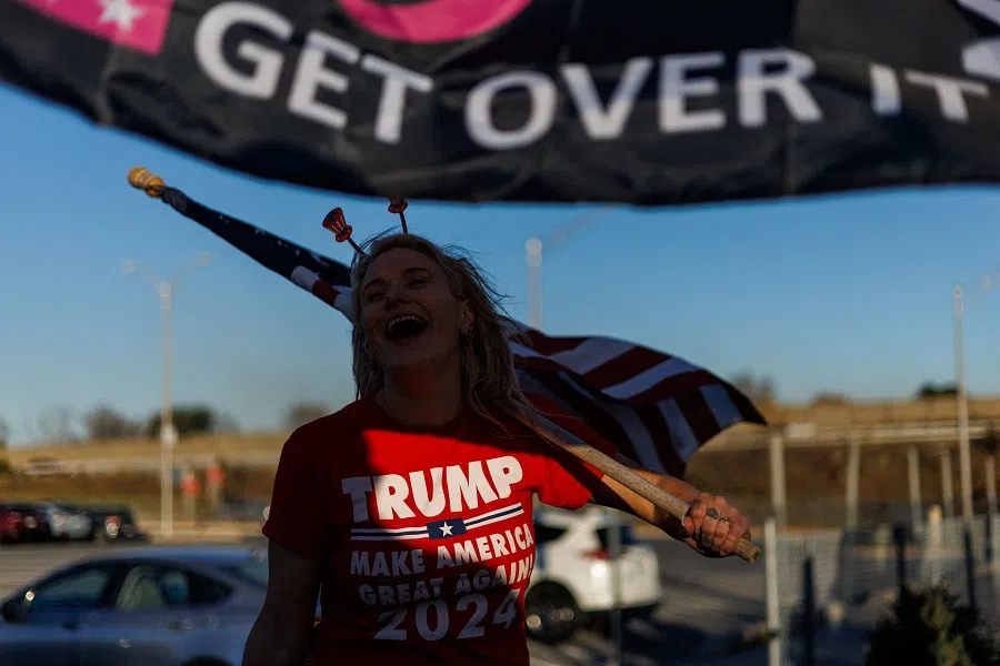Supporters of former President and Republican presidential nominee Donald Trump gather along William Penn Highway to wave pro-Trump and American flags during rush hour in Easton, Pennsylvania, US, on 1 November 2024. (Samuel Corum/AFP)