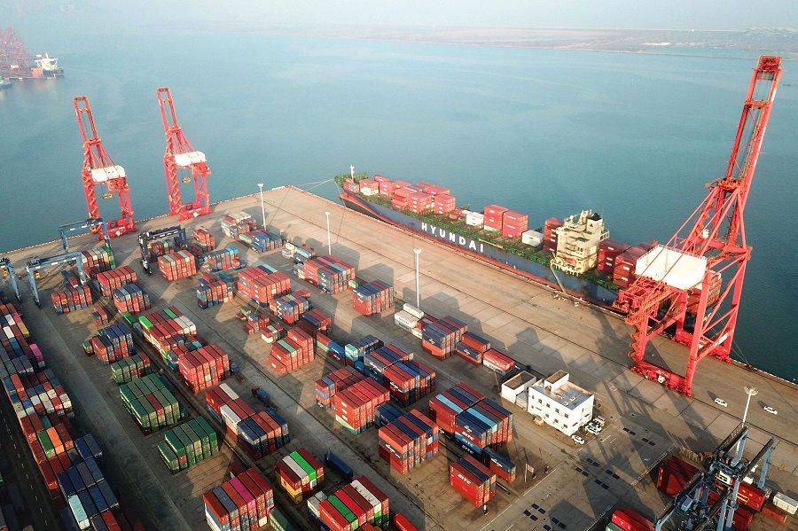 This aerial photo taken on 7 December 2021 shows containers and gantry cranes at a port in Lianyungang, Jiangsu province, China. (AFP)