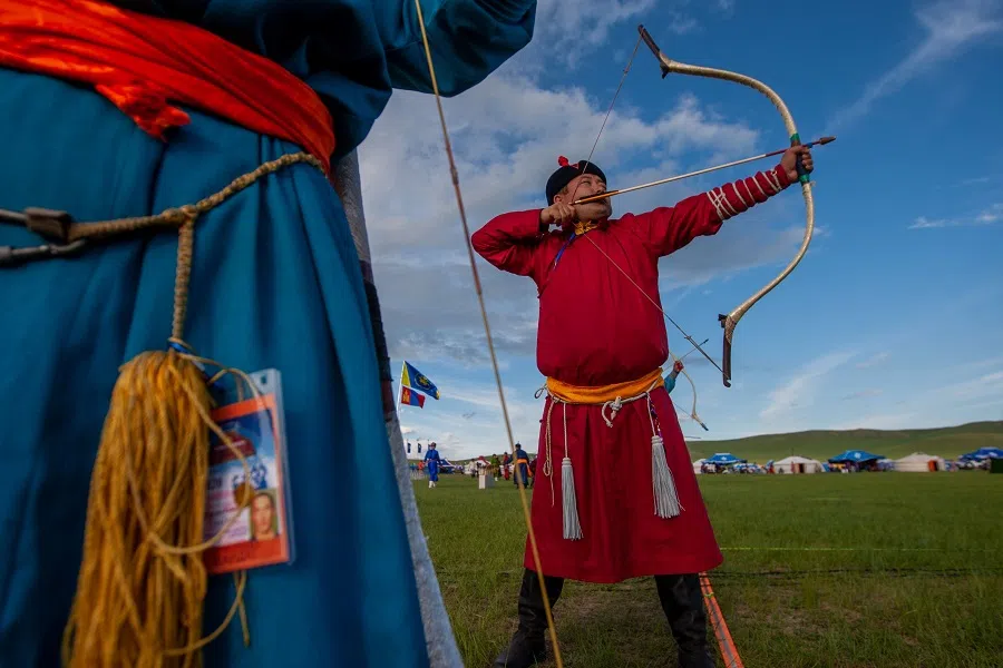 This photo taken on 11 July 2020 shows competitors during an archery competition at the annual Naadam sports festival near Ulaanbaatar, in Mongolia. (Byambasuren Byamba-ochir/AFP)