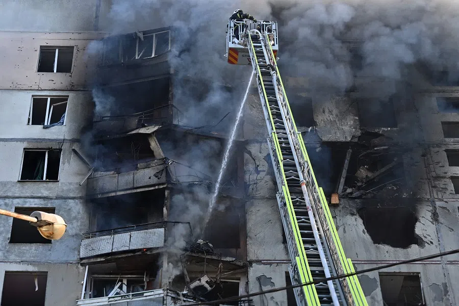 Ukrainian rescuers work to extinguish a fire in a residential building following a missile attack in Kharkiv on 15 September 2024, amid the Russian invasion of Ukraine. (Sergey Bobok/AFP)