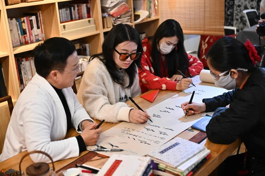 A calligraphy workshop in Beijing on 14 April 2025. (Pedro Pardo/AFP)
