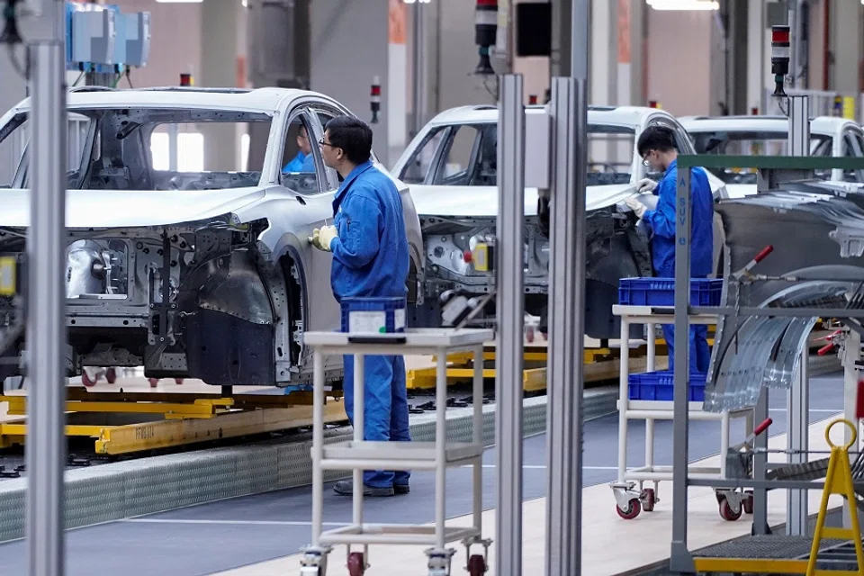 Employees work on the assembly line during a construction completion event of SAIC Volkswagen MEB electric vehicle plant in Shanghai, China, 8 November 2019. (Aly Song/File Photo/Reuters)