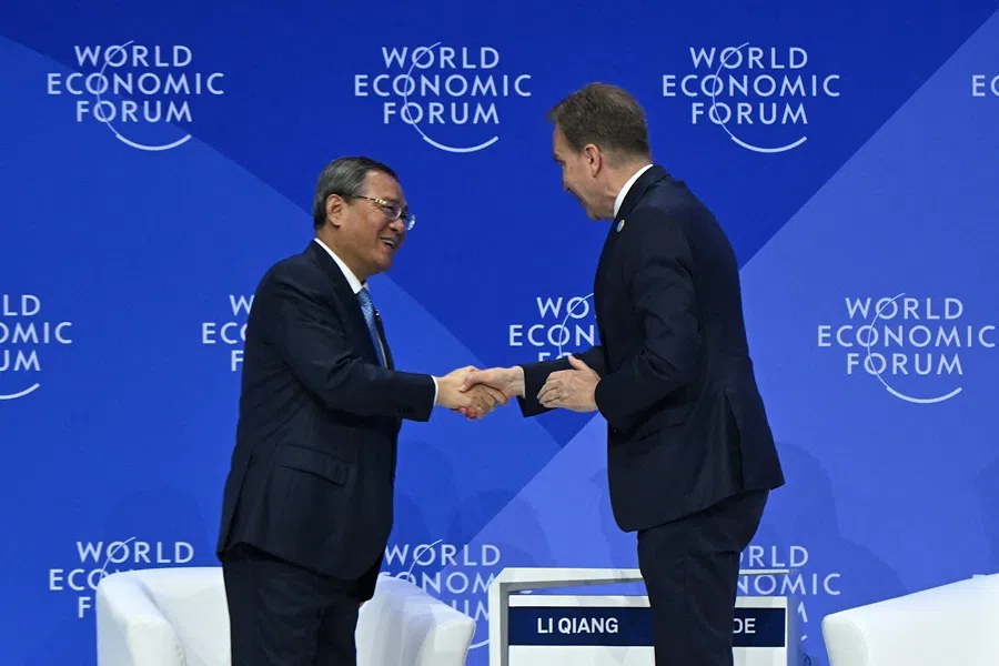 Chinese Premier Li Qiang (left) shakes hands with president and CEO of the World Economic Forum Borge Brende after concluding his speech during the opening ceremony of the World Economic Forum Annual Meeting of the New Champions (AMNC25) in Tianjin on 25 June 2025.  (Jade Gao/AFP)